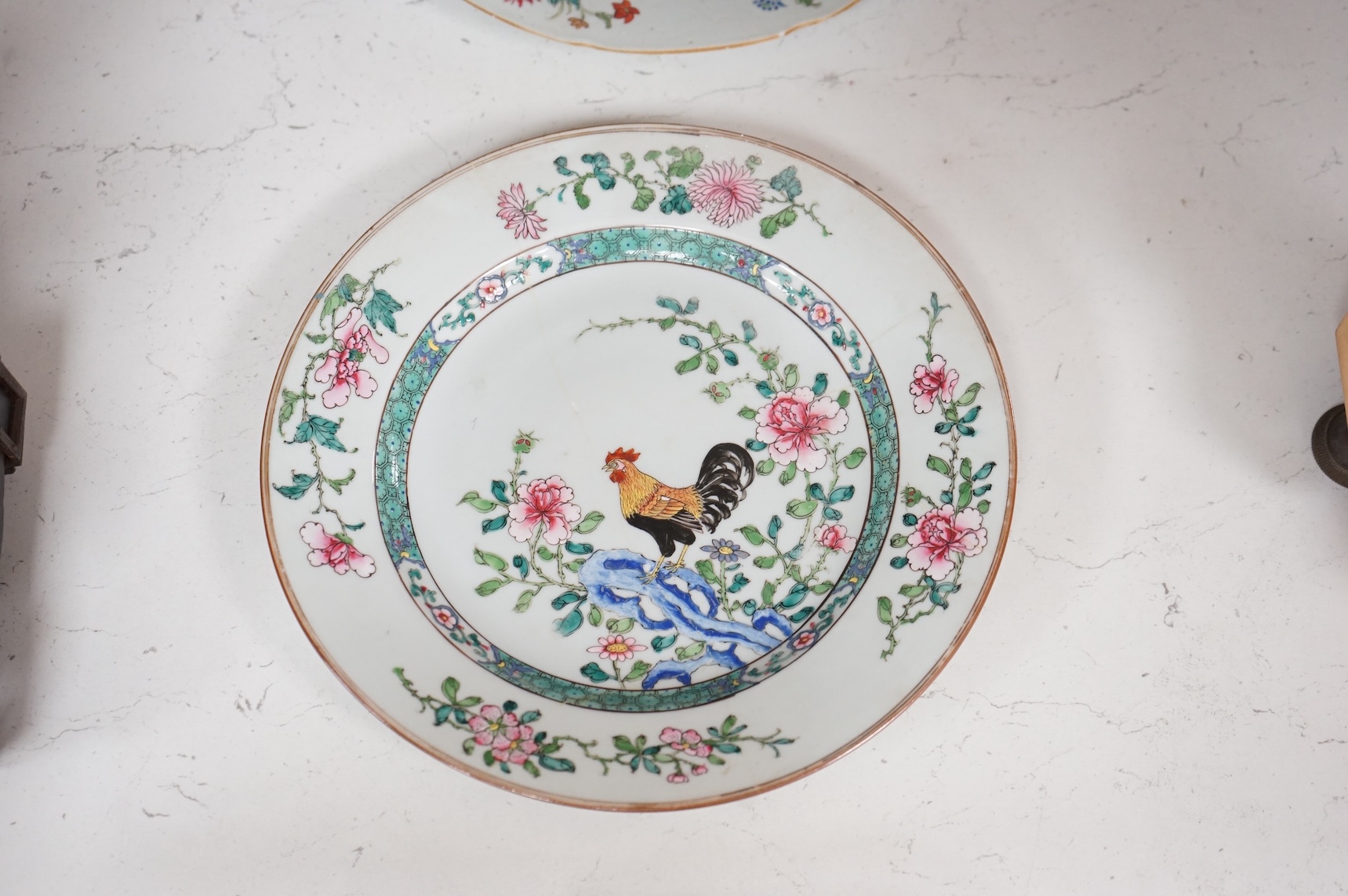 Three Chinese famille rose plates, Qianlong, including an armorial example, largest 22.5cm in diameter